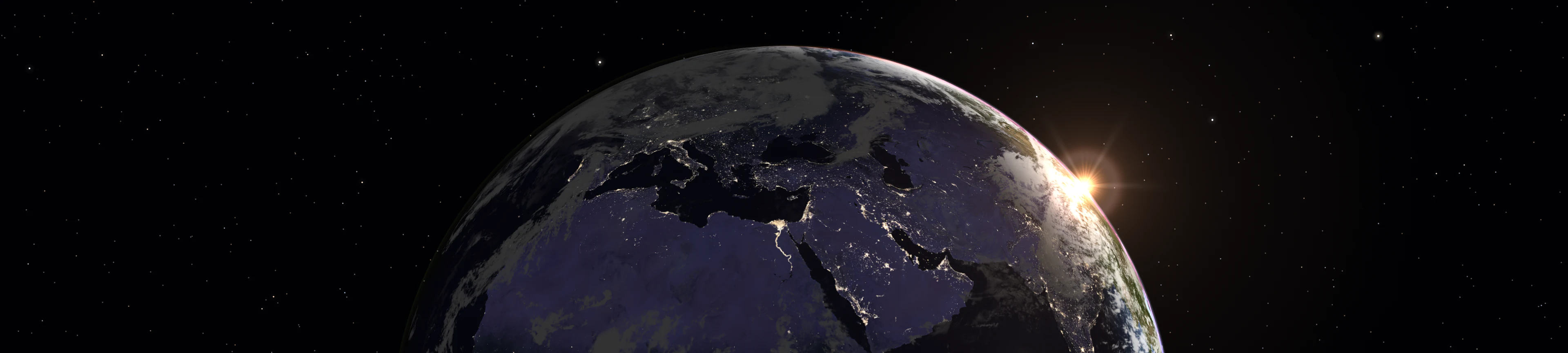 Sunrise over Earth, with city lights beneath a starry sky
